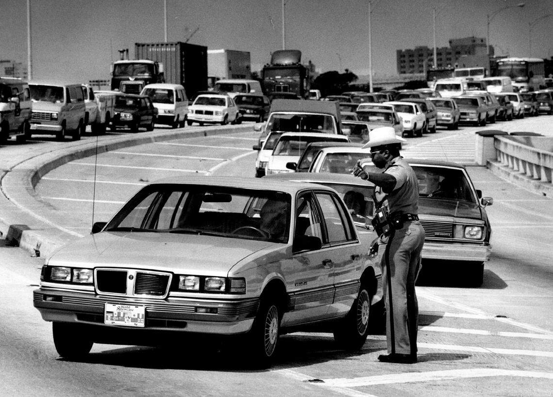 A trooper directs traffic after the MacArthur Causeway bridge got stuck in 1990.