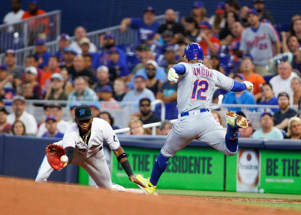 Miami Marlins first baseman Lewin Diaz (34) eyes on the baseball as New York Mets shortstop Francisco Lindor (12) reaches safely into first base during the second inning of a baseball game at LoanDepot Park on Sunday, July 31, 2022 in Miami, Florida.