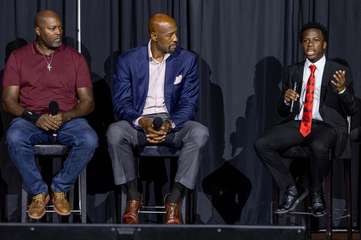 5,000 Role Models mentor Semaj Gilliard, 18, right, Miami Heat Vice President of Player Programs and Development Alonzo Mourning, center, and former Heat forward Glen Rice, left, speak to the audience during a 5000 Role Models Police & Youth Conference.