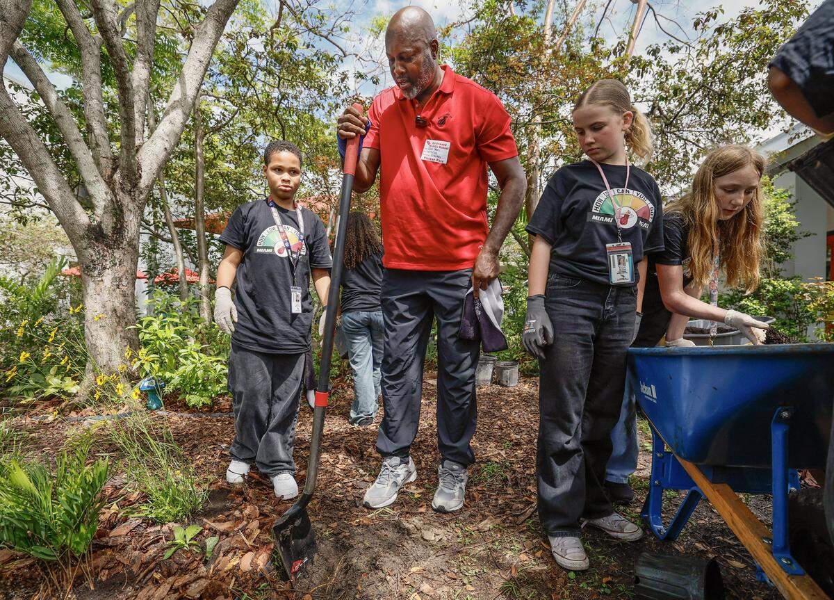Former NBA player Glen Rice works with students as the school prepares for Earth Day, as the Miami Heat transforms the outdoor area at Driftwood Middle School by installing a new garden and updating the interior. Featuring a butterfly garden, planting beds, and indoor hydroponic towers, students help by planting flowers, vegetables, and greenery, creating a welcoming and peaceful environment in Hollywood, Florida, on Thursday, April 9, 2026. 