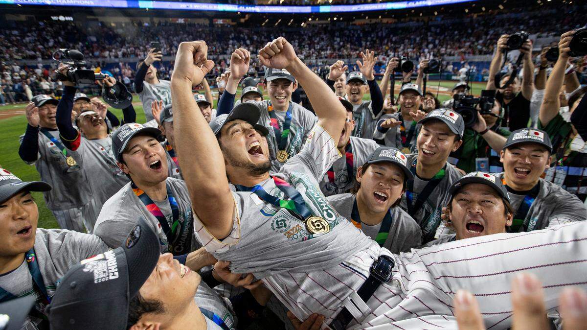 Japan pitcher Yu Darvish (11) celebrates with his teammates during an award ceremony after defeating the United States in the championship game at the World Baseball Classic at loanDepot Park on Tuesday, March 21, 2023, in Miami, Fla.