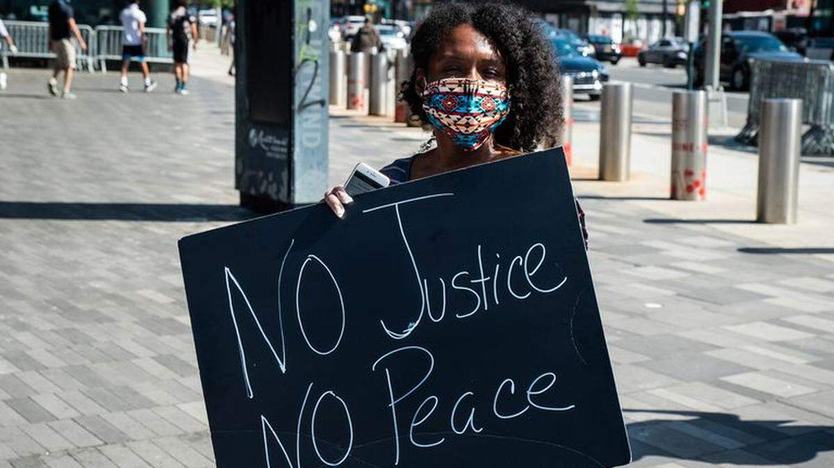 A woman in Brooklyn, New York, protests George Floyd’s death.