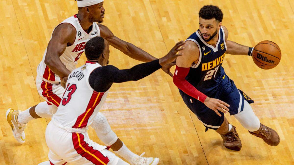 Denver Nuggets point guard Jamal Murray (27) drives while defended by Miami Heat forward Jimmy Butler (22) and center Bam Adebayo (13) during the first half of Game 4 of the NBA Finals at the Kaseya Center on Friday, June 9, 2023, in downtown Miami, Fla.