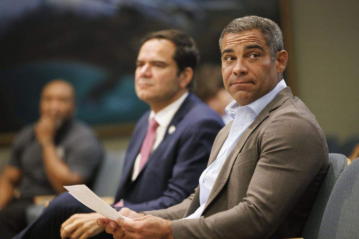 Miami Mayor Francis Suarez, right, and Commissioner Ralph Rosado, left, sit before a press conference they held to provide funding for enrollment in the “Fast Track to Citizenship” course for Miami residents on Monday, July 28, 2025, at Miami City Hall in Coconut Grove.