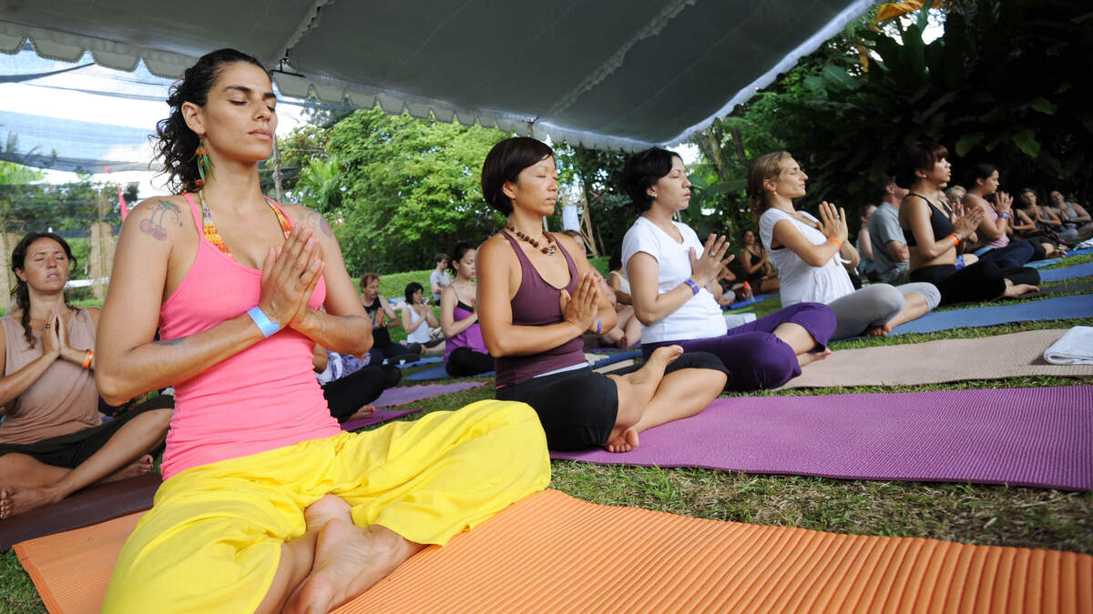 In this photograph taken on March 26, 2011 a group of yoga practitioners partake in the Bali Spirit Festival in Ubud.