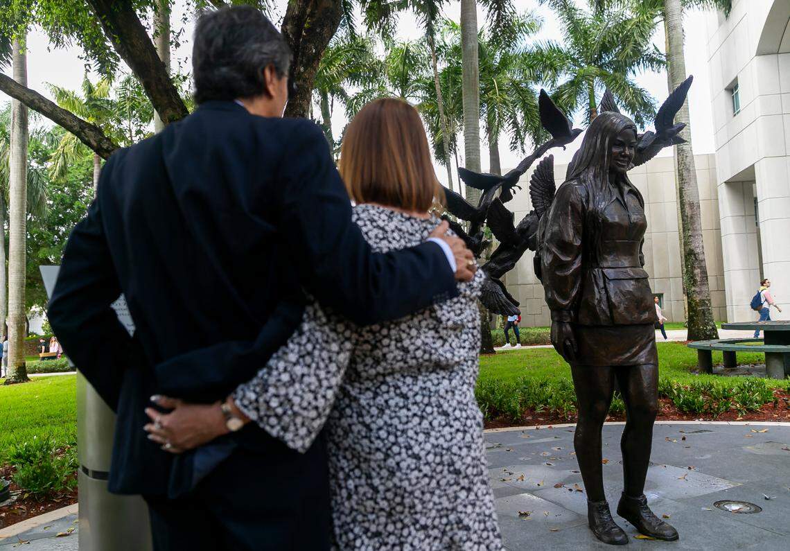 Gina Duran and Orlando Duran, the parents of Alexa Duran, embrace on Tuesday, March 15, 2022, during the unveiling of a memorial at Florida International University in Miami, Florida on the fourth anniversary of the FIU bridge collapse. Their 18-year-old daughter, Alexa, was killed with five others when the FIU pedestrian footbridge collapsed as it was being built across Southwest Eighth Street on March 15, 2018. The sculpture, commissioned by FIU, commemorates Alexa and the five others who died.