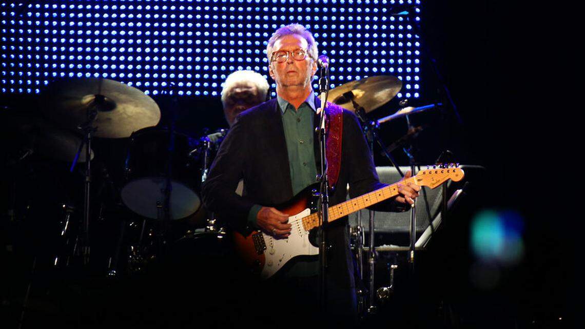 Eric Clapton, center, performs during his “70th Birthday Celebration” concert at Madison Square Garden on Friday, May 1, 2015, in New York. On Wednesday, Clapton said that he will not perform at venues that require their guests to have a COVID-19 vaccine.