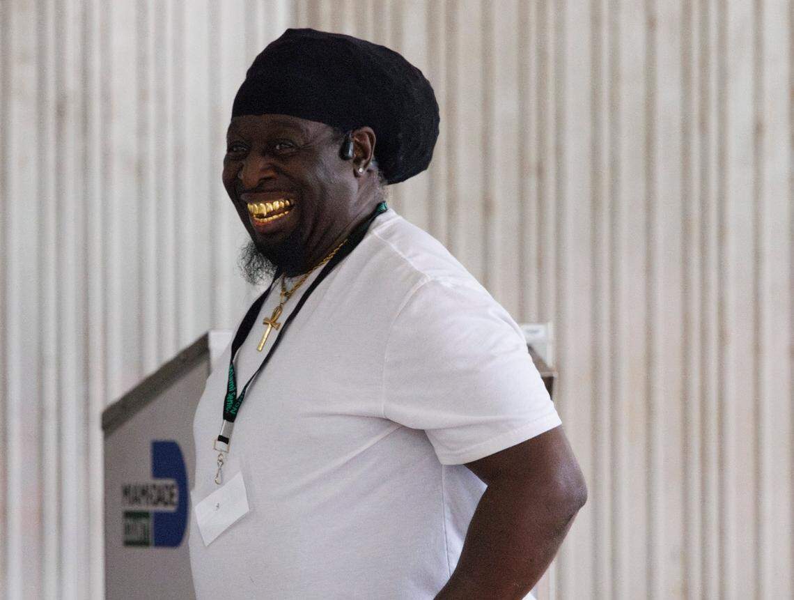 A man smiles after dropping off his mail in ballot on Election Day on Tuesday, Nov. 5, 2024, at Stephen P Clark Government Center in downtown Miami.