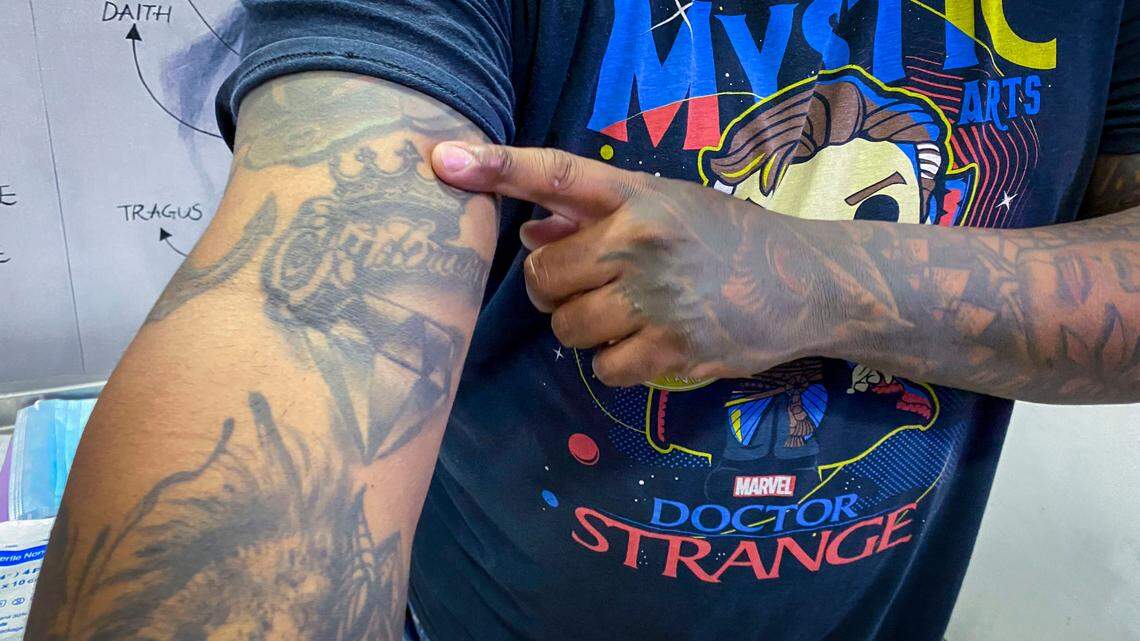 Mauricio Araujo shows off his tattoos.