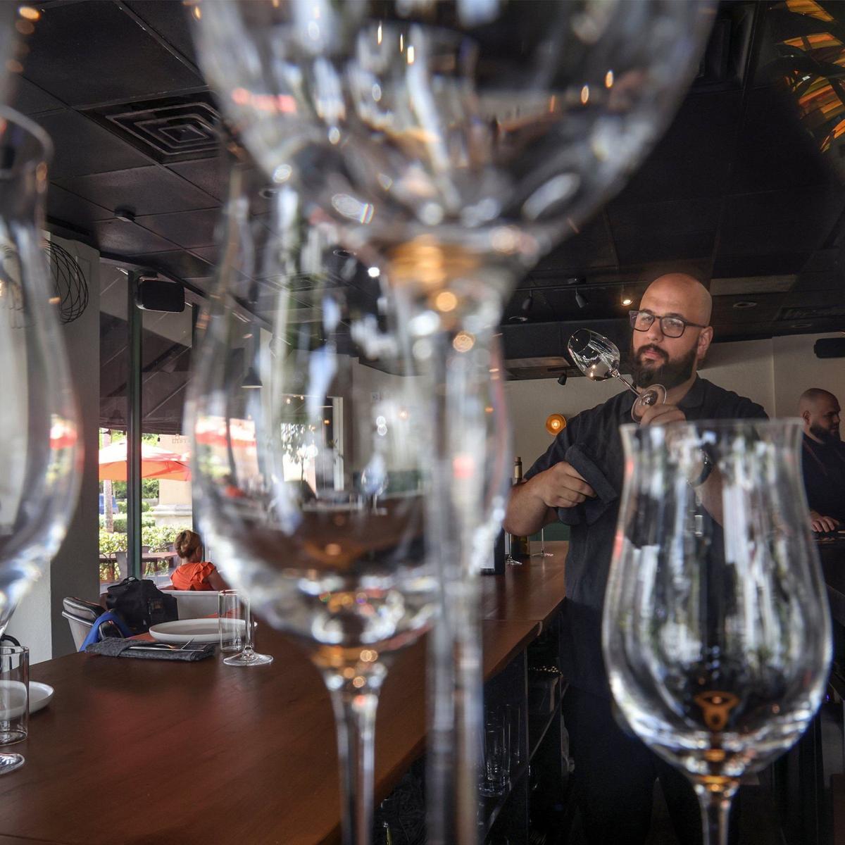 Pedro Mederos, 31, right, cleans a wine glass at the new Kojin 2.0 in Coral Gables.