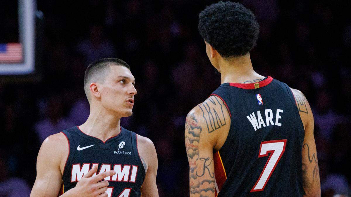 Miami Heat guard Tyler Herro (14) and center Kel’el Ware (7) talk during the first half of a game against the LA Clippers on March 12, 2025, at Kaseya Center in Miami.