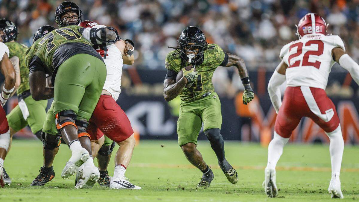 Miami Hurricanes running back Mark Fletcher Jr. (4) on a carry in the first half against the Stanford Cardinal during their NCAA football game at Hard Rock Stadium in Miami Gardens, Florida, on Saturday, October 25, 2025.