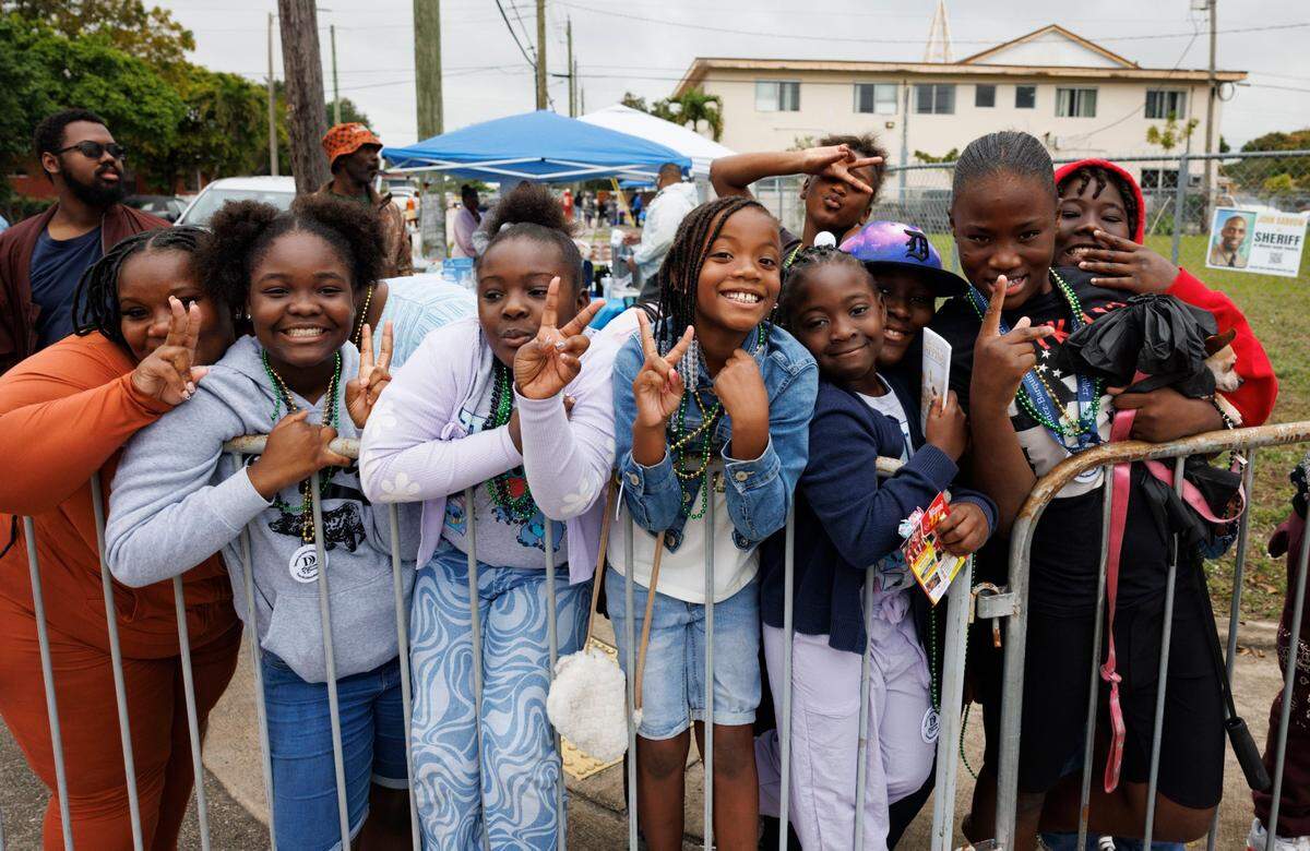 Ava Hayes, center, and friends pose while watching the Dr. Martin Luther King Jr. Day parade on Monday, Jan. 20, 2025, in Liberty City in Miami, Fla.
