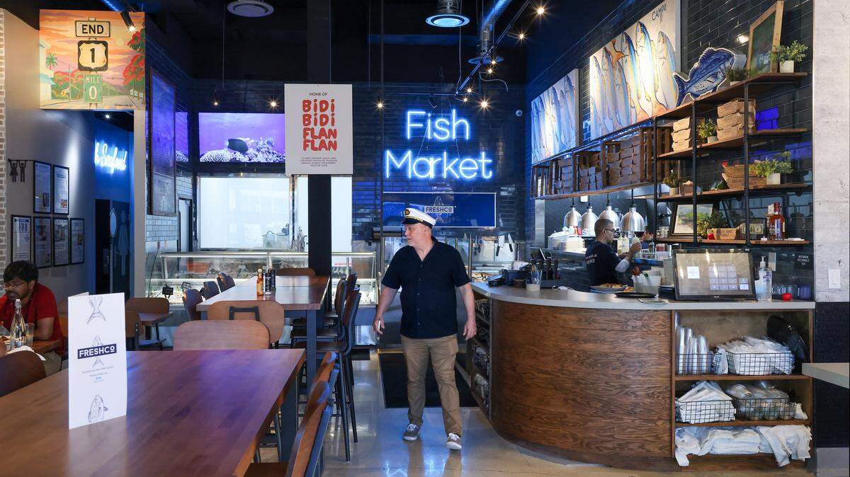 Mario Palazon dons his captain hat as he and his wife opened their new FreshCo Fish in Doral, Florida, as they opened his new 127-seat restaurant on Wednesday, December 24, 2025.