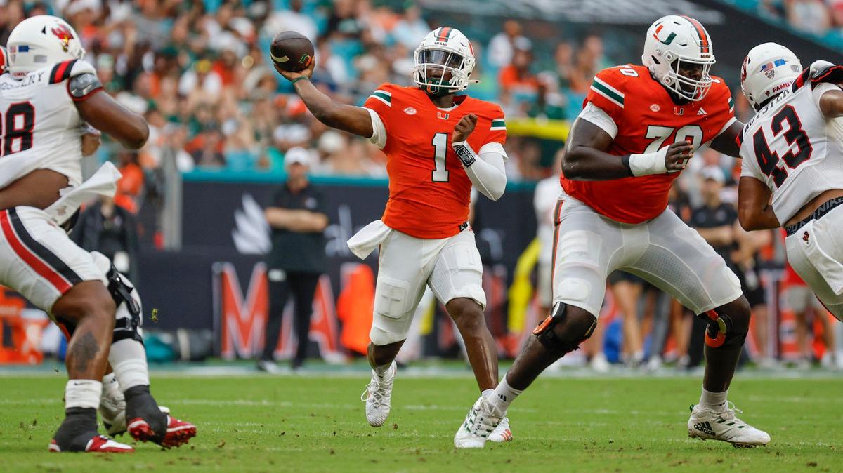 Miami Hurricanes quarterback Cam Ward (1) throws a touchdown pass to wide receiver Xavier Restrepo (7) in the first half of an NCAA football game against the Ball State Cardinals at Hard Rock Stadium in Miami Gardens, Florida on Saturday, September 14, 2024.