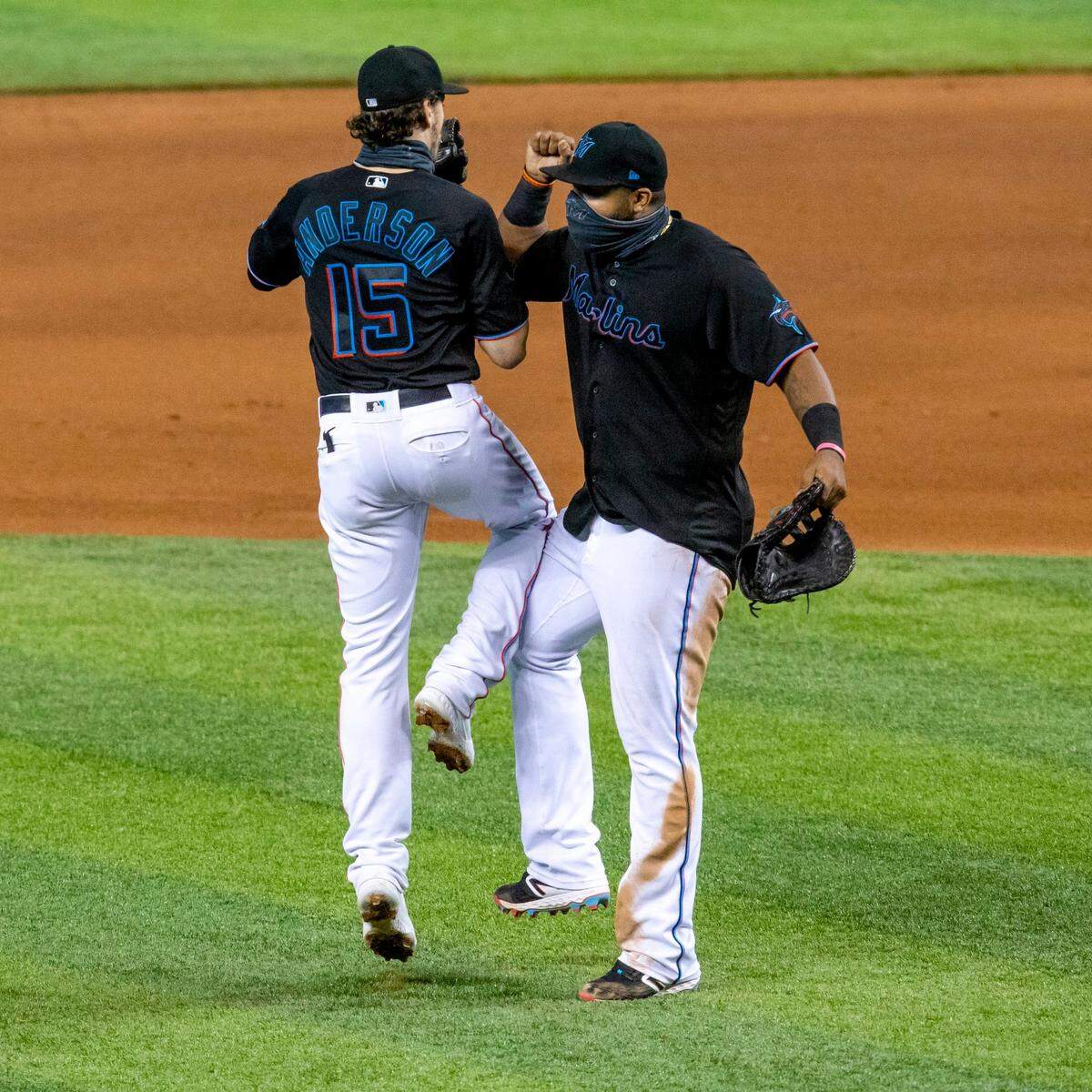 Miami Marlins third baseman Brian Anderson (15) and first baseman Jesus Aguilar (24) leap in the air to celebrate a 8-1 win over the Philadelphia Phillies in the second game of a double header at Marlins Park in Miami, Florida on Sunday, September 13, 2020.