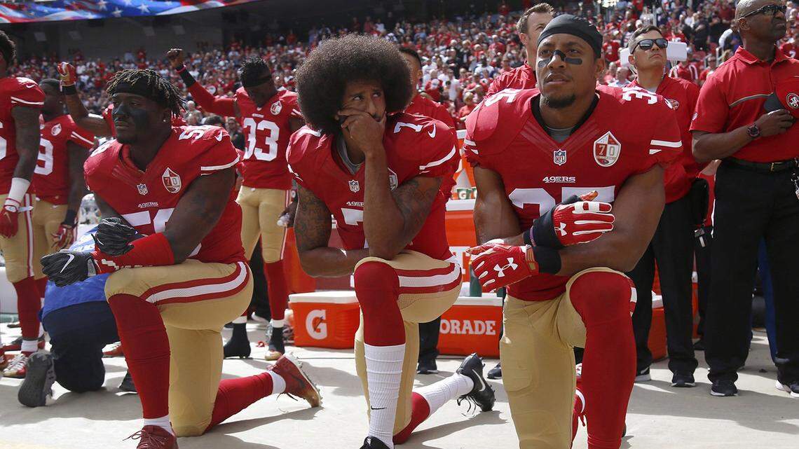 The San Francisco 49’s Eli Harold (58), Colin Kaepernick (7) and Eric Reid (35) kneel during the national anthem before a game against the Dallas Cowboys on October 2, 2016, at Levi’s Stadium in Santa Clara, Calif.