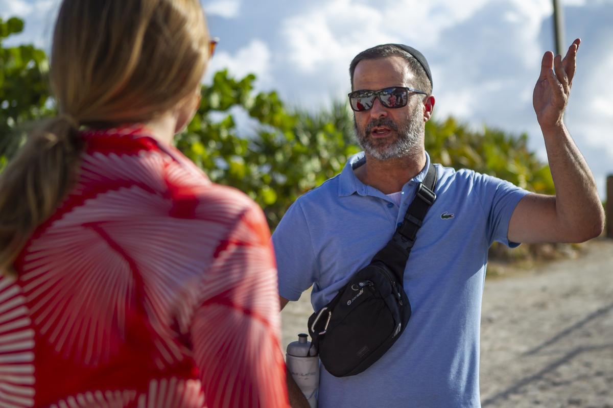 Robert Lansburgh, a South Beach resident, talks with Elizabeth Wheaton, director of Miami Beach’s Environment and Sustainability Department, about his concerns regarding the path Miami Beach is building on dunes.