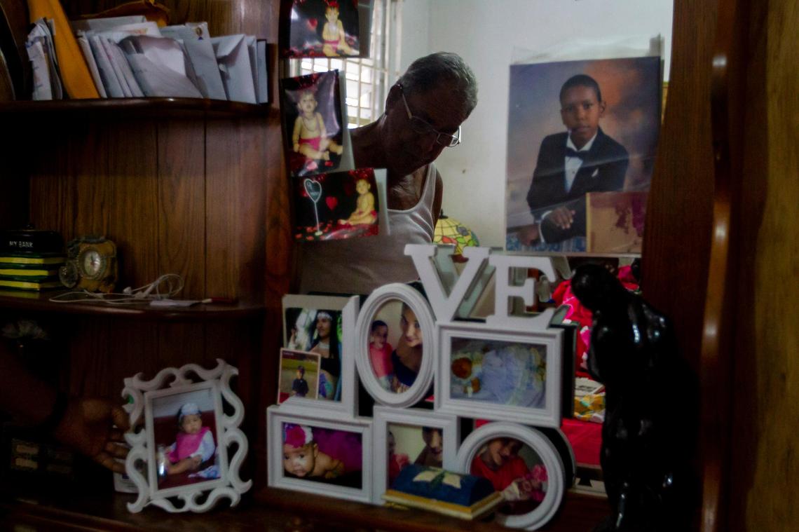 Roberto Rivera Rosario, 75, shows off family photos in his rain damaged bedroom on August 24, 2018. Rivera Rosario’s home in Barriada Bitumur in San Juan, Puerto Rico was severely damaged by Hurricane Maria.
