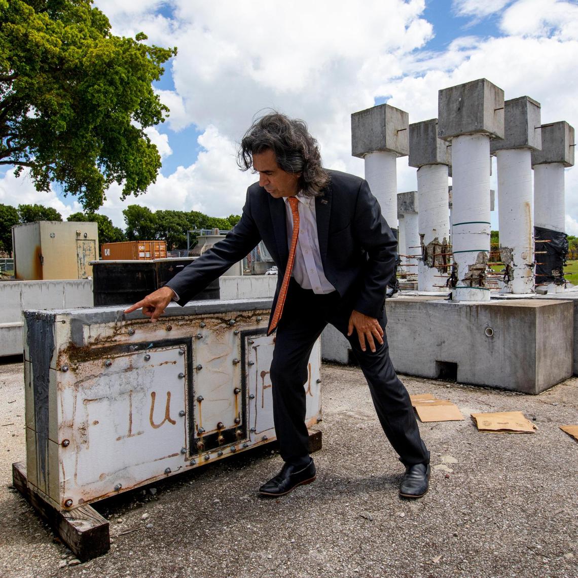 Atorod Azizinamini, Vasant Surti professor of civil engineering and director of Moss School of Construction, Infrastructure and Sustainability at Florida International University explains an experiment on a piece of concrete while outside the Structures Lab at FIU College of Engineering & Computing in Miami, Florida, on Tuesday, August 10, 2021.