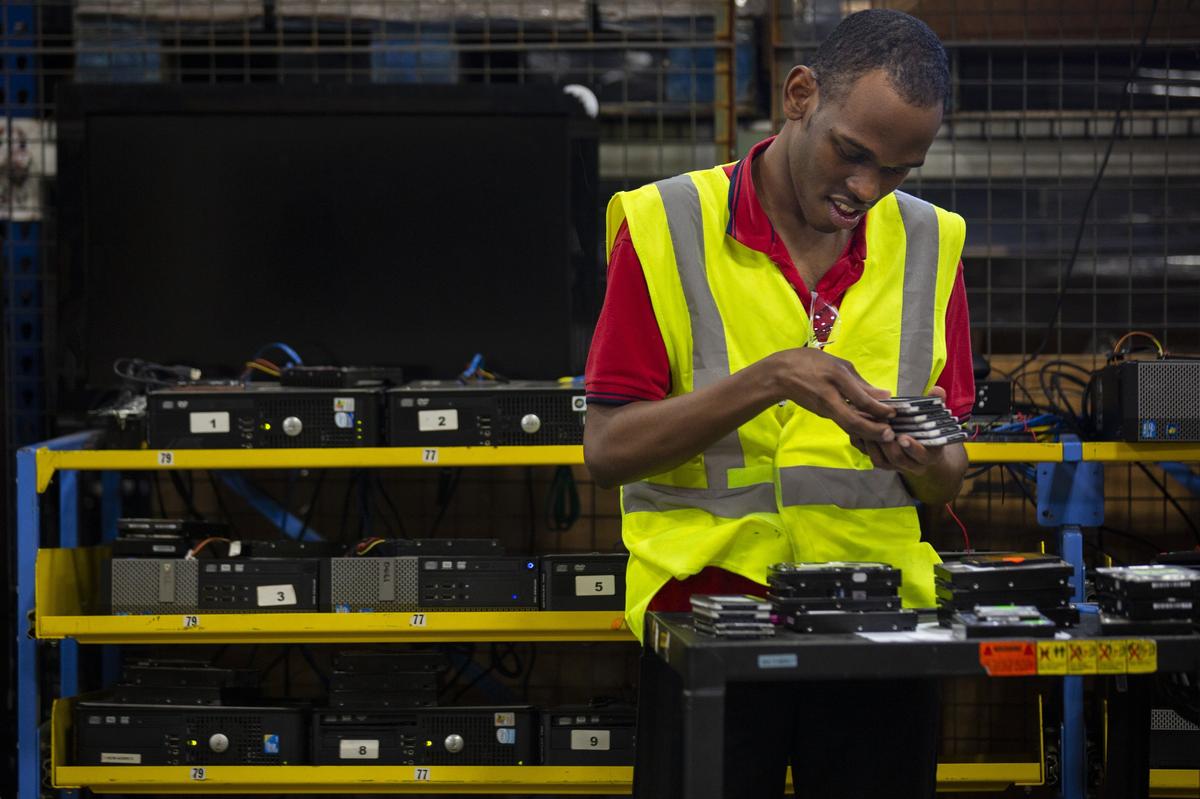Daniel Diedrick, 22, a student at Arc Tech, works to safely dispose of hard drives in a warehouse in Fort Lauderdale. Arc Tech, one of three social enterprises of Arc Broward, uses its hard drive disposal fees to support people with disabilities.