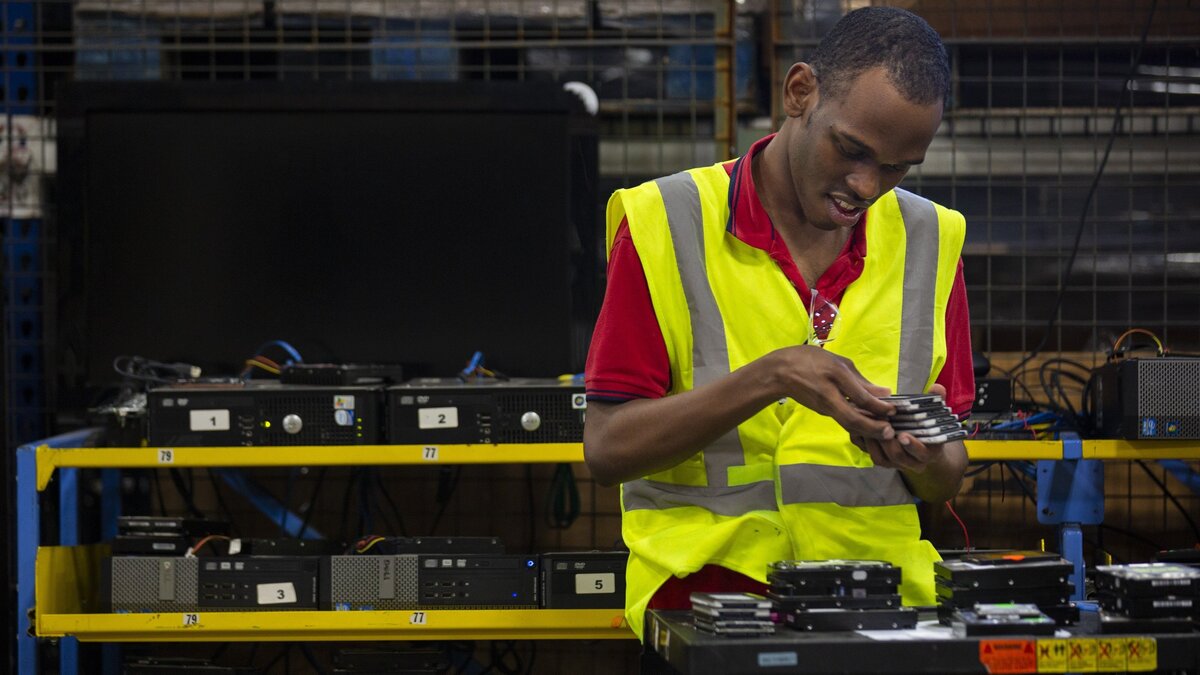 Daniel Diedrick, 22, a student at Arc Tech, works to safely dispose of hard drives in a warehouse in Fort Lauderdale. Arc Tech, one of three social enterprises of Arc Broward, uses its hard drive disposal fees to support people with disabilities.