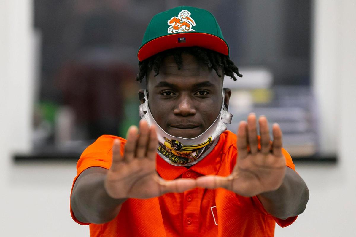 James Williams reacts after signing with the University of Miami during National Signing Day at American Heritage School in Plantation, Florida on Wednesday, December 16, 2020.