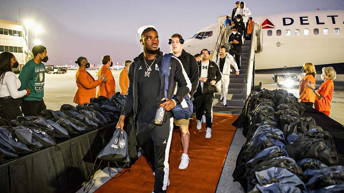 Michigan Wolverines football players arrive in South Florida on Saturday, Dec. 25, 2021, ahead of their College Football Playoff semifinal game against the Georgia Bulldogs at the Orange Bowl.