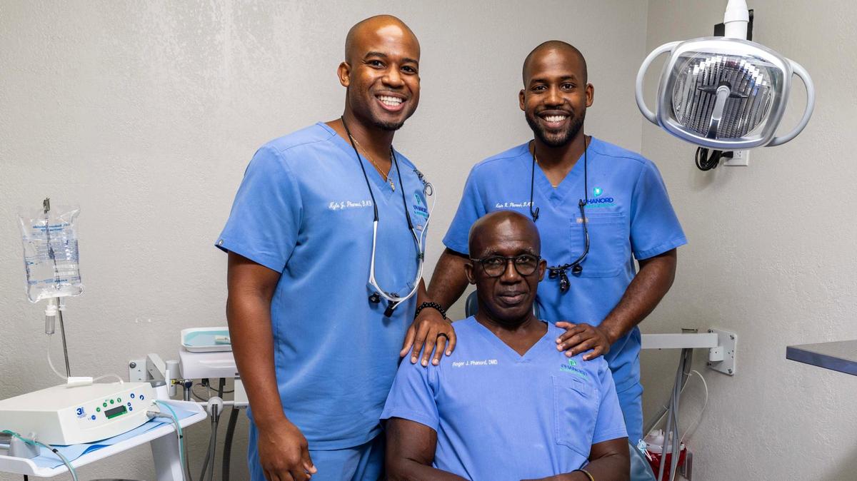 Father and sons trio Dr. Roger Phanord, Dr. Kevin Phanord and Dr. Kyle Phanord strike a pose at the offices of Phanord & Associates on Monday, June 9, 2025, in North Miami, Florida.