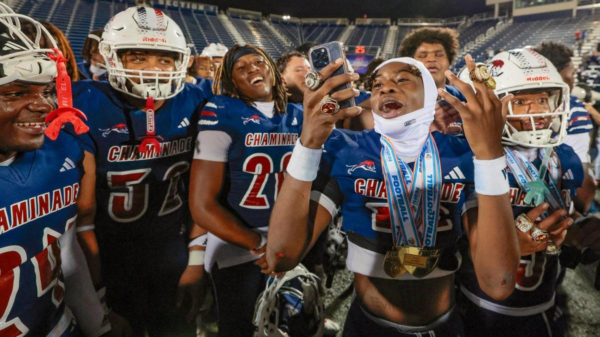 Chaminade-Madonna’s Kelly Sejour Jr. (12) holds up his State Championship rings as he celebrates with teammates after defeating Clearwater Central Catholic in the Florida High School Football State Championships - Class 1A game at Pitbull Stadium on the campus of Florida International University in Miami, Florida, on Wednesday, December 11, 2024.