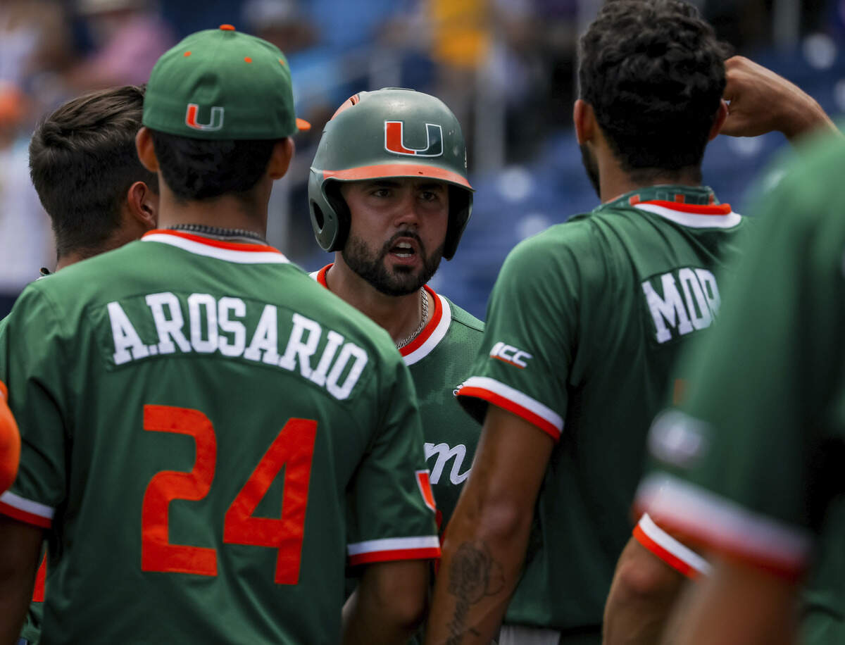 Miami Hurricanes fourth-year junior Alex Toral is surrounded by his teammates in UM baseball’s final game of 2021 season against South Alabama on Sunday, June 6, 2021.