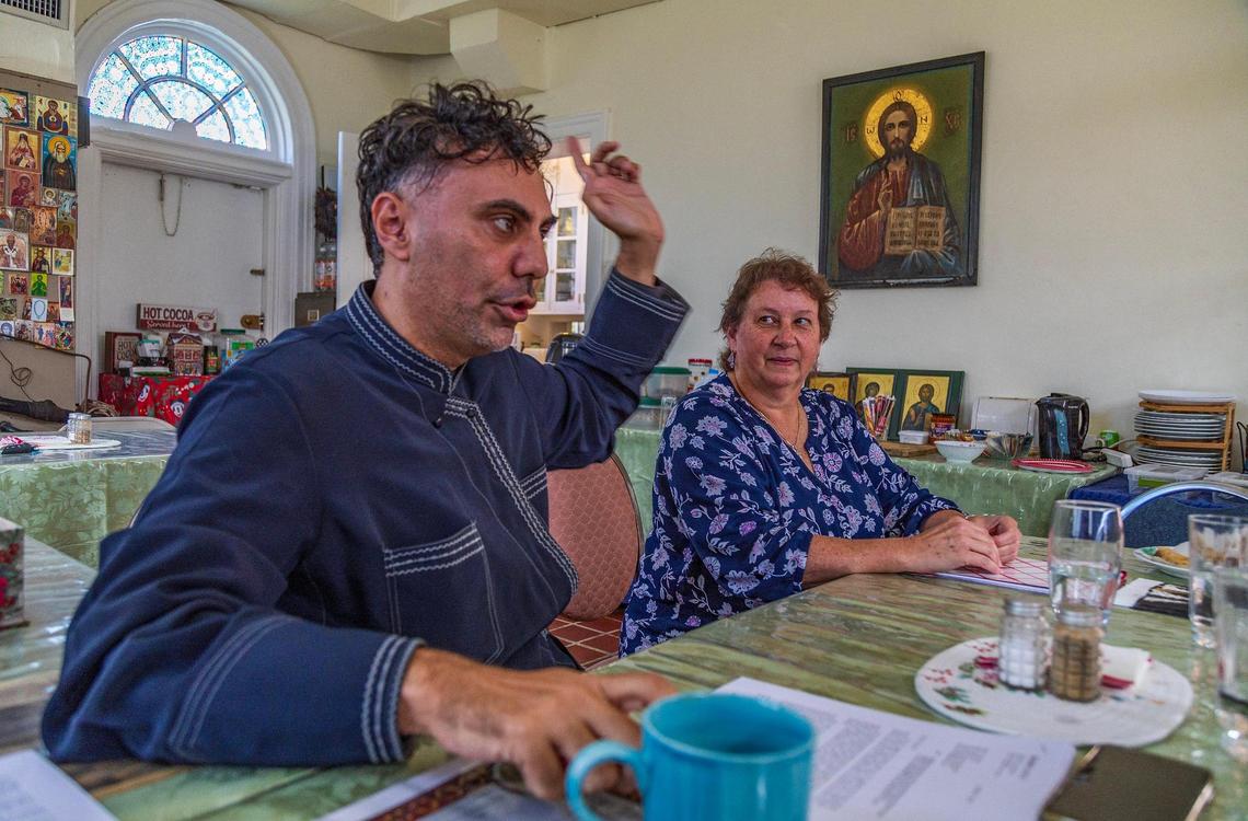 Deacon Georgios Zervos and parish leader Susan Homyk speak with reporters in the shop at Saints Peter and Paul Russian Orthodox Greek Catholic Church in Little Havana, one of Miami’s oldest Eastern Orthodox parishes, housed in the onetime home of Miami’s first mayor.