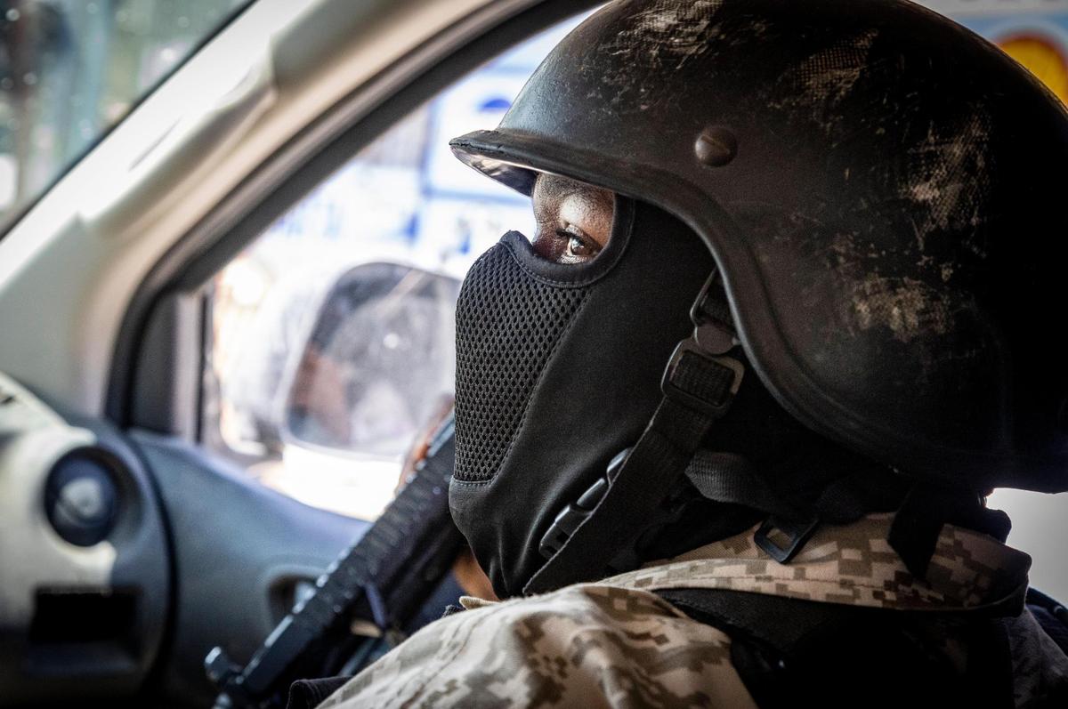 A Haitian policeman sits in the passenger seat of a police vehicle while on patrol in the streets of Tabarre in metropolitan Port-au-Prince, Haiti, on June 23, 2022.