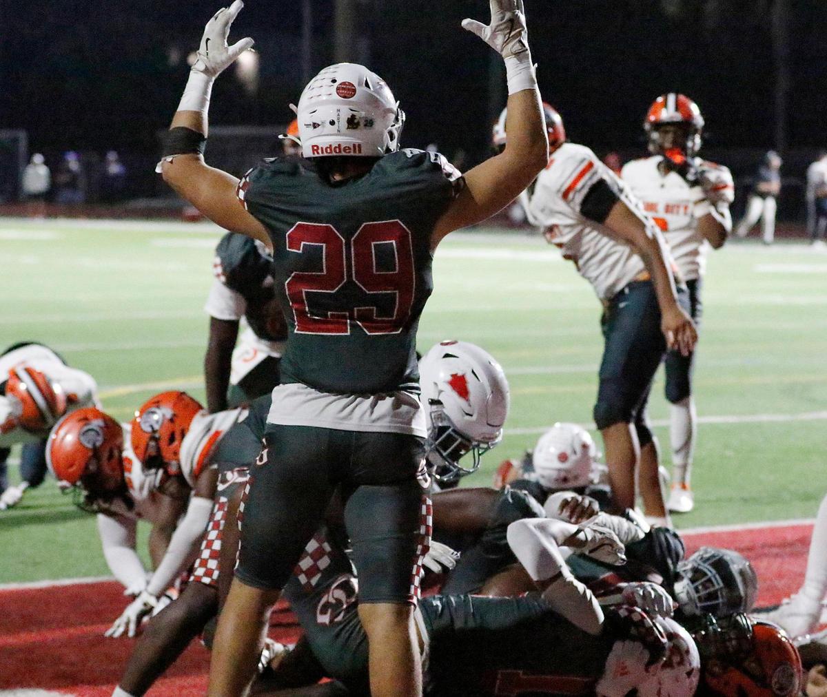 Cardinal Gibbons Chiefs celebrate a touchdown against Carol City Chiefs during regional quarterfinal football game on Friday, November 15, 2024 at Cardinal Gibbons HS in Fort Lauderdale. Andrew Uloza / for Miami Herald