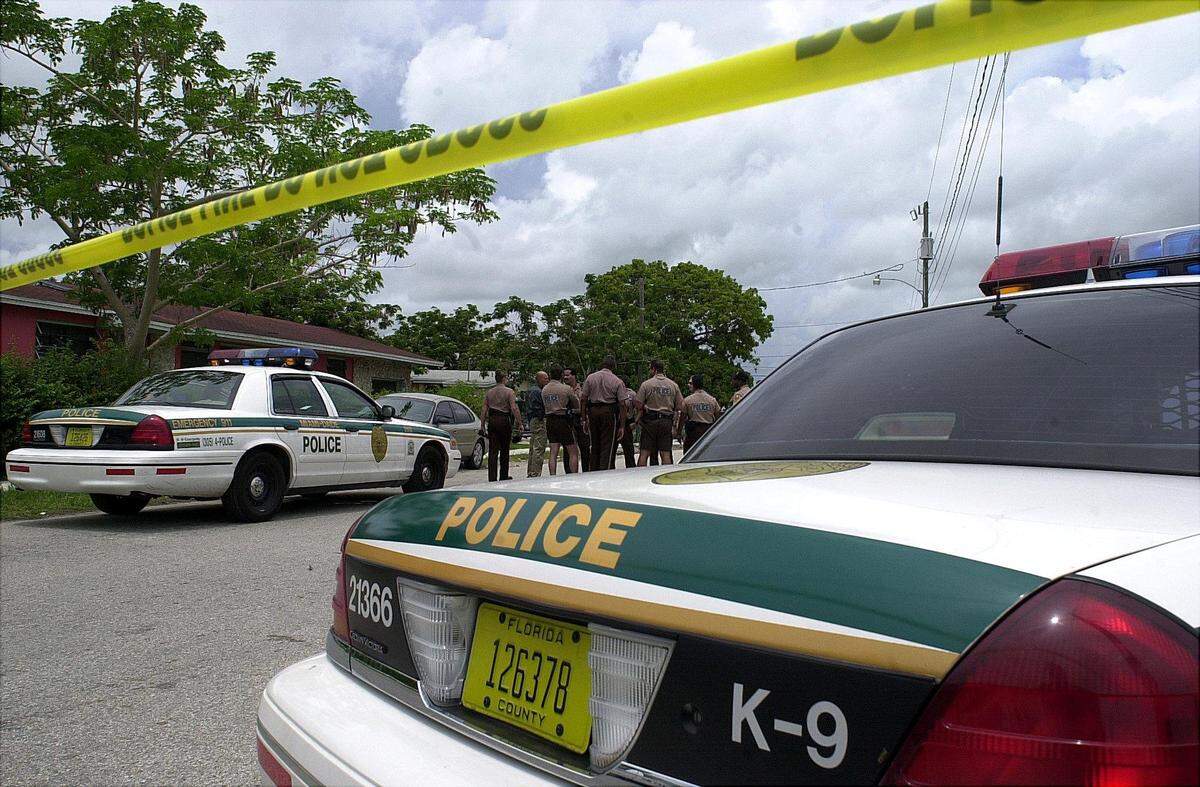 -In 2001, Metro police officers get ready to conduct a search for suspects in South Miami-Dade.