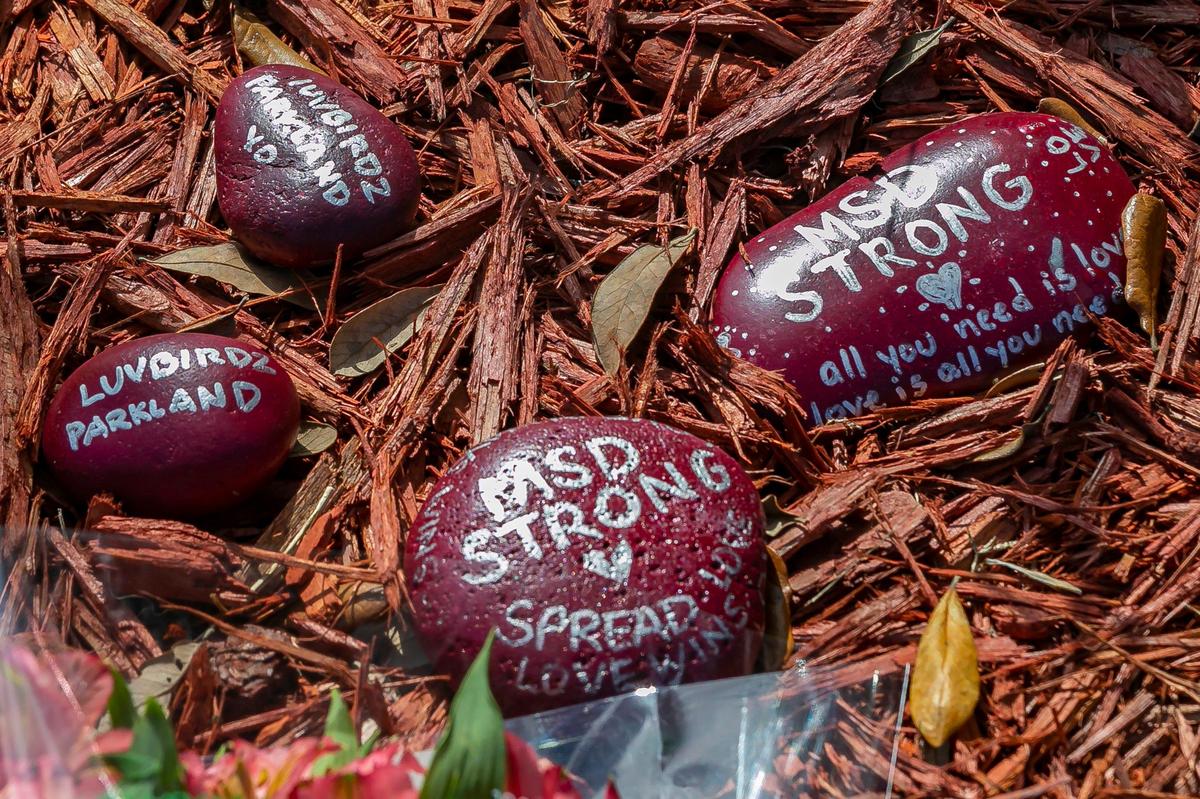 Painted rocks with messages decorate a makeshift memorial outside of Marjory Stoneman Douglas High School on Friday, Feb. 14, 2020, on the two-year anniversary of the Parkland shooting where 17 victims were killed.