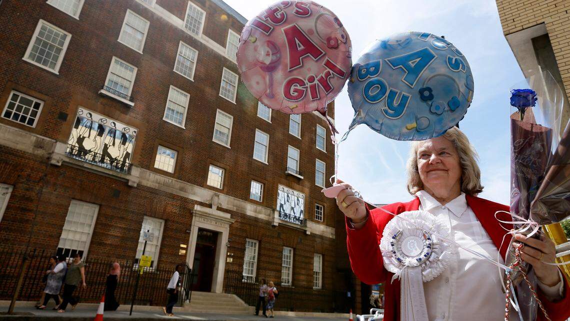 Royal supporter Margaret Tyler displays balloons for the media in front of the Lindo Wing at St Mary’s Hospital in London, Monday, July 15, 2013. Britain’s Kate, the Duchess of Cambridge plans to give birth to her first child who will be third-in-line to the throne at the hospital in mid-July. While mega-fanfare awaits the gender reveal of the latest British royal, parents-to-be weigh in on finding out the gender of their own little bundle ahead of time. (AP Photo/Kirsty Wigglesworth)