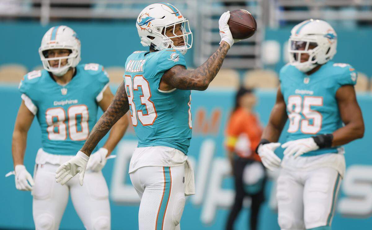 Miami Dolphins tight end Darren Waller (83) tosses a ball before an NFL football game against the Jacksonville Jaguars at Hard Rock Stadium in Miami Gardens, Florida, on Saturday, August 23, 2025.
