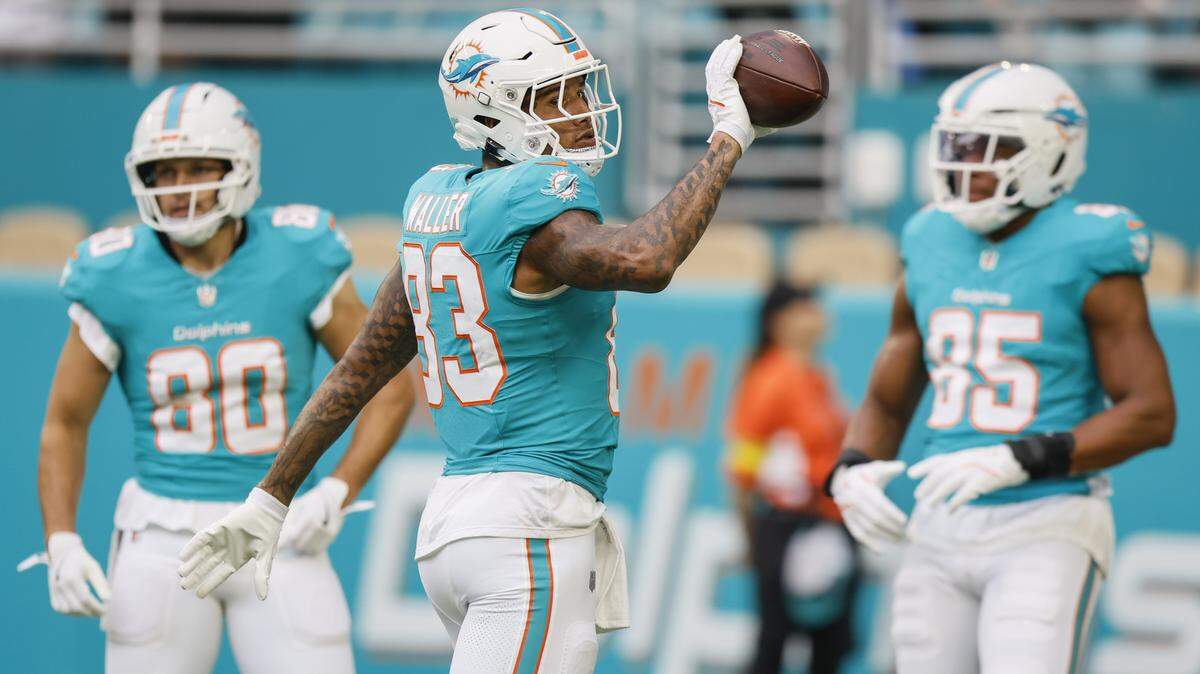 Miami Dolphins tight end Darren Waller (83) tosses a ball before an NFL football game against the Jacksonville Jaguars at Hard Rock Stadium in Miami Gardens, Florida, on Saturday, August 23, 2025.