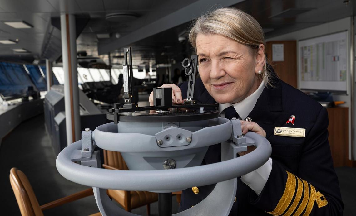 Queen Anne’s Captain Inger Klein Thorhauge uses a gyroscope on the Cunard ship’s bridge while it is docked at PortMiami on Tuesday, Jan. 21, 2025, in Miami, Fla.