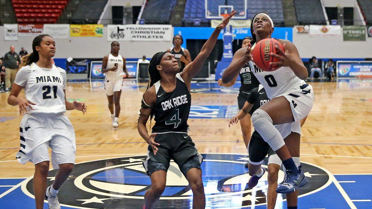 Miami HS Shekinah Rachel (0) leaps for a basket past Oak Ridge HS Eriana Taylor in the 9A Semi-Finals Girl’s State Basketball Championships at the RP Funding Center in Lakeland, Florida, Friday, March, 1, 2019.