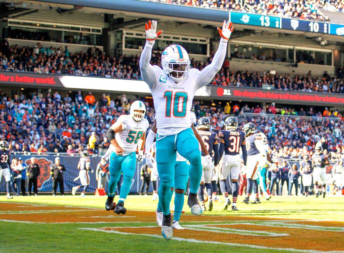 Miami Dolphins wide receiver Tyreek Hill (10) celebrates after scoring a touchdown during second quarter of an NFL football game against the Chicago Bears at Soldier Field on Sunday, November 6, 2022 in Chicago, Illinois.