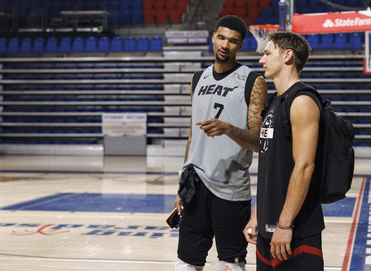 Kel'el Ware (7) talks to Pelle Larsson (9) during the first day of Miami Heat Training Camp on Sept. 30, 2025, at Florida Atlantic University in Boca Raton.