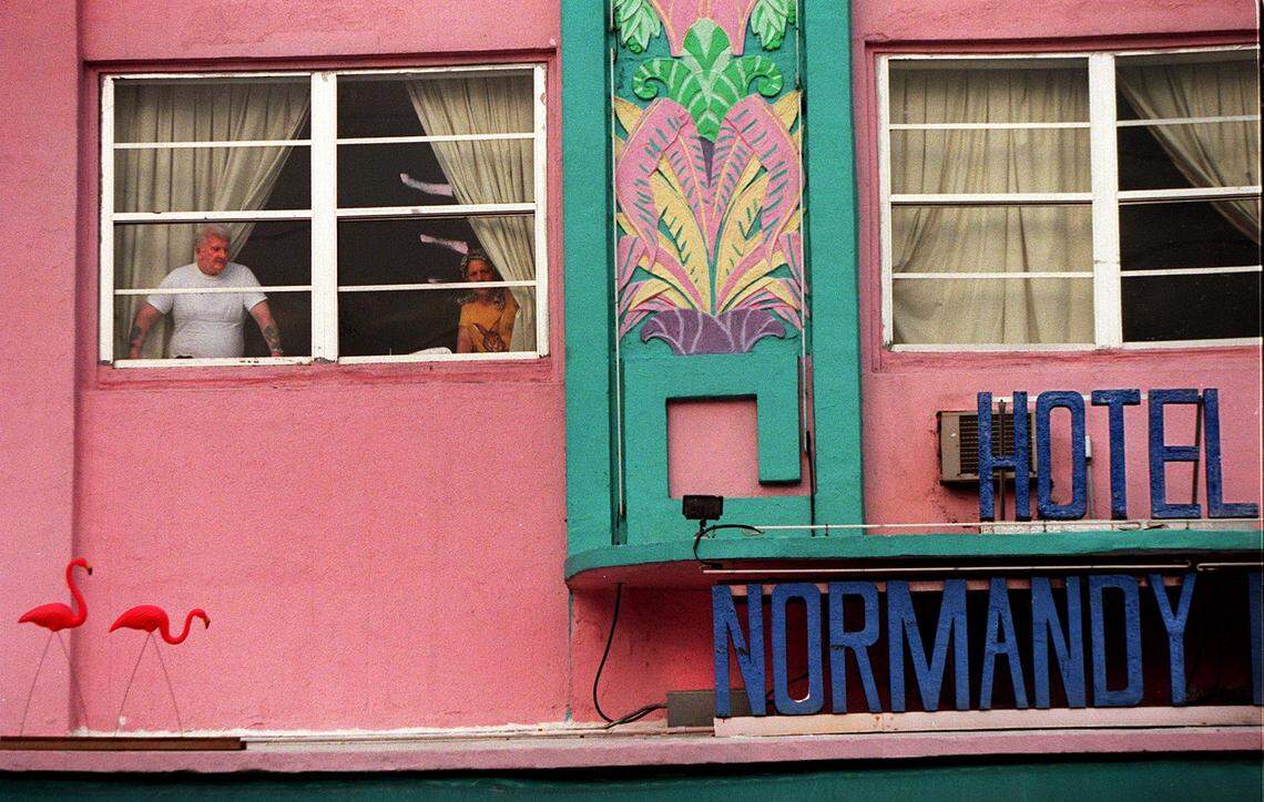 7/18/97 Al Diaz/Herald staff-- Guests look out the window of The Normandy Plaza Hotel at 6979 Collins Ave. in Miami Beach. A suspect in the Gianni Versace murder case stayed at the hotel. Police collected evidence from the hotel. S. Fla Out; No Sales; No Mags.