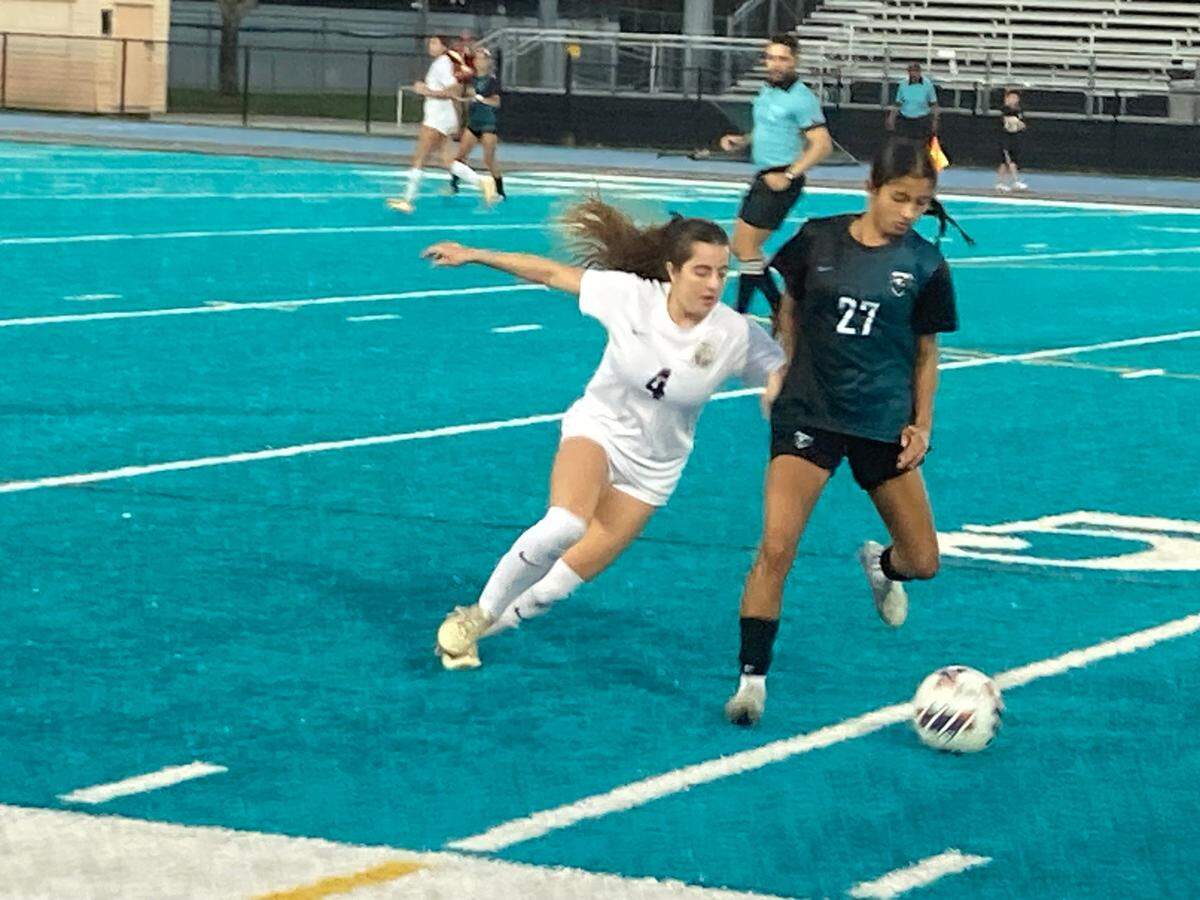 Pines Charter’s Catalina Castro (4) tries to outduel McCarthy’s Valentina Huertas for a loose ball during Friday’s Region 4-5A girls regional semifinal at McCarthy High School.