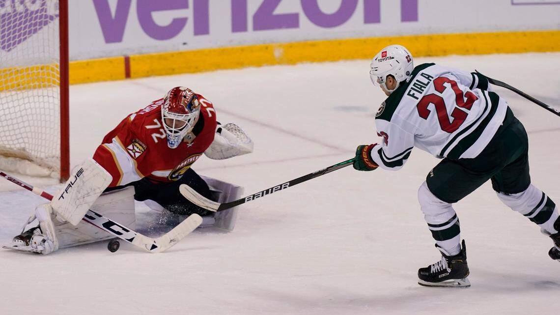 Florida Panthers goaltender Sergei Bobrovsky (72) stops a shot on goal by Minnesota Wild left wing Kevin Fiala (22) during the second period at an NHL hockey game, Saturday, Nov. 20, 2021, in Sunrise, Fla. (AP Photo/Marta Lavandier)