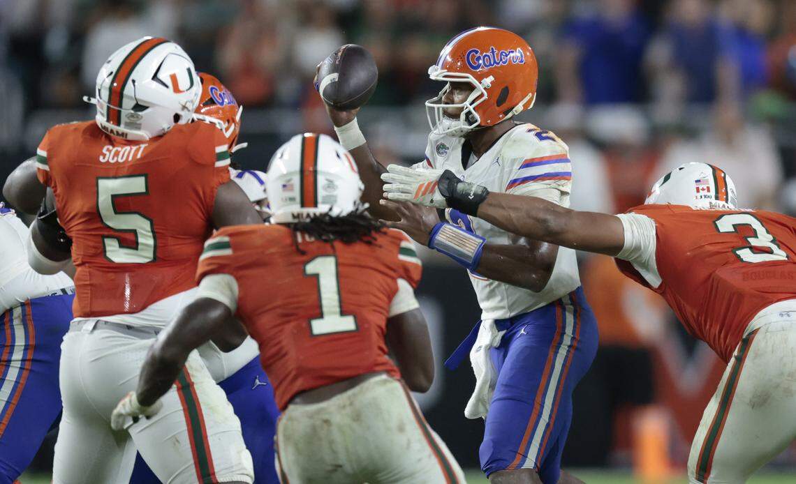 Miami Hurricanes defensive lineman Justin Scott (5), linebacker Mohamed Toure (1) and defensive lineman Akheem Mesidor (3) pressure Florida Gators quarterback DJ Lagway (2) in the second half of their NCAA football game at Hard Rock Stadium in Miami Gardens, Florida, on Saturday, September 20, 2025.