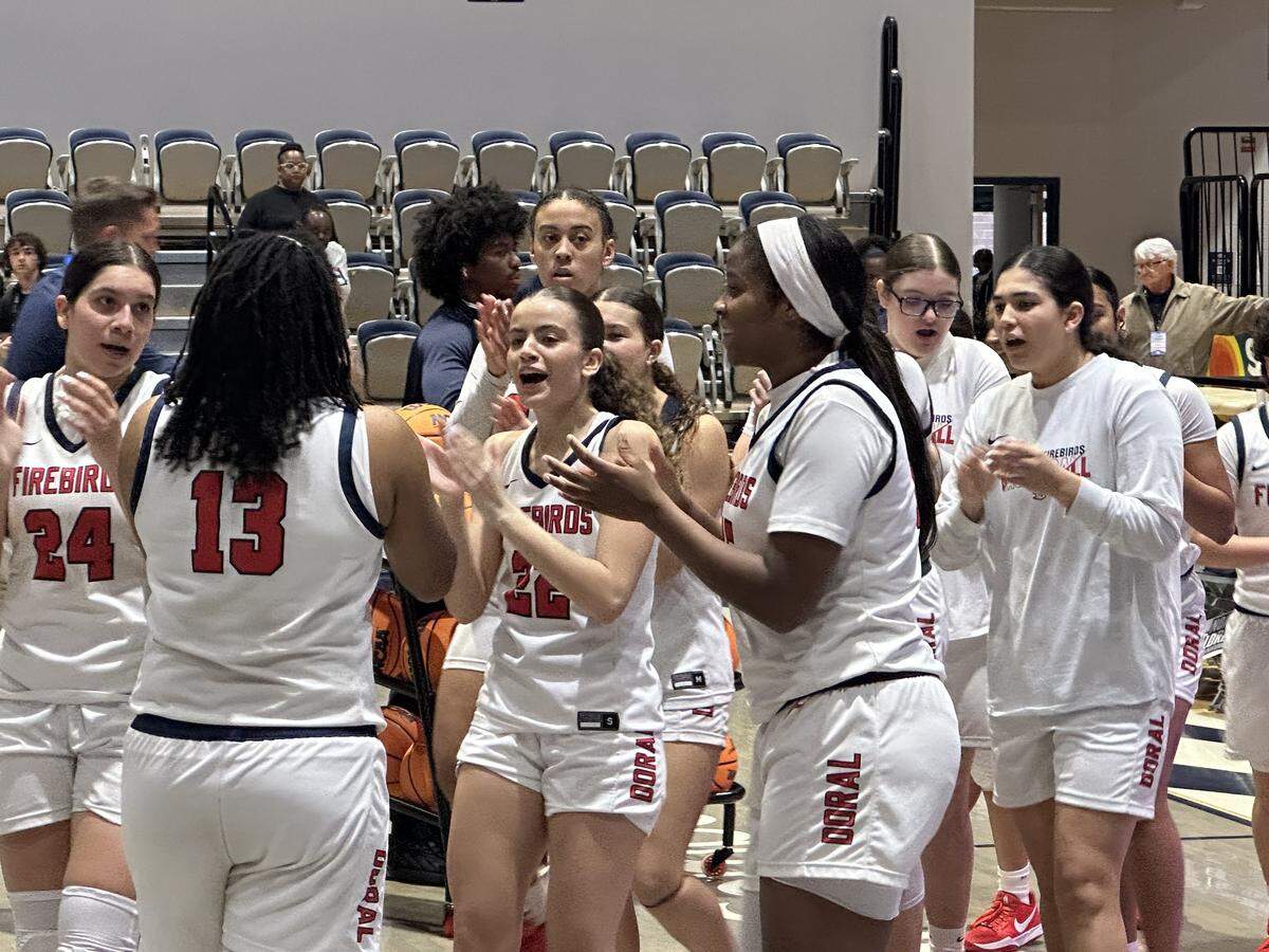 Doral Academy girls’ basketball players congratulate each other as they walk off the court following their 71-46 victory over Port St. Lucie Centennial on Friday in a Class 7A state semifinal at UNF Arena in Jacksonville, Fla.