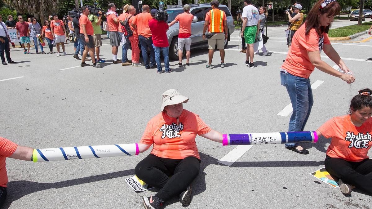 Demonstrators block drivers at the intersection  of Southwest 29th Street and 145th Avenue during a protest in July outside the U.S. Immigration and Customs Enforcement field office in Miramar. Protesters decried what they say is “inhumane treatment” of immigrant families and called on the U.S. to abolish ICE.