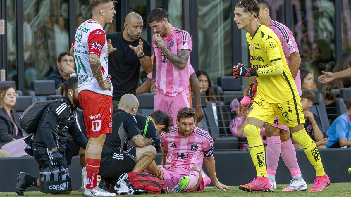 Inter Miami CF forward Lionel Messi (10) receives medical attention after being tripped by Necaxa forward Raúl Sánchez (11) during the first half of their Leagues Cup Phase One match at Chase Stadium on Saturday, Aug. 2, 2025, in Fort Lauderdale, Fla. Messi exited the match following the incident